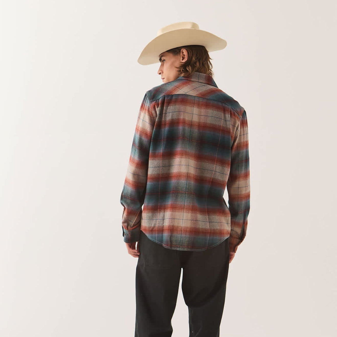 Male model wearing the Brixton Men's Bowery Flannel in Multi Shadow on plain background.