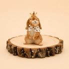 Camp Hollow Highness Hare Cake Topper on a beige background at Addison West