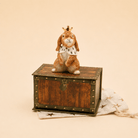 Camp Hollow Highness Hare Cake Topper on a beige background at Addison West
