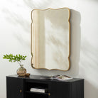 Imelda Accent Mirror on a white wall above a table at Addison West