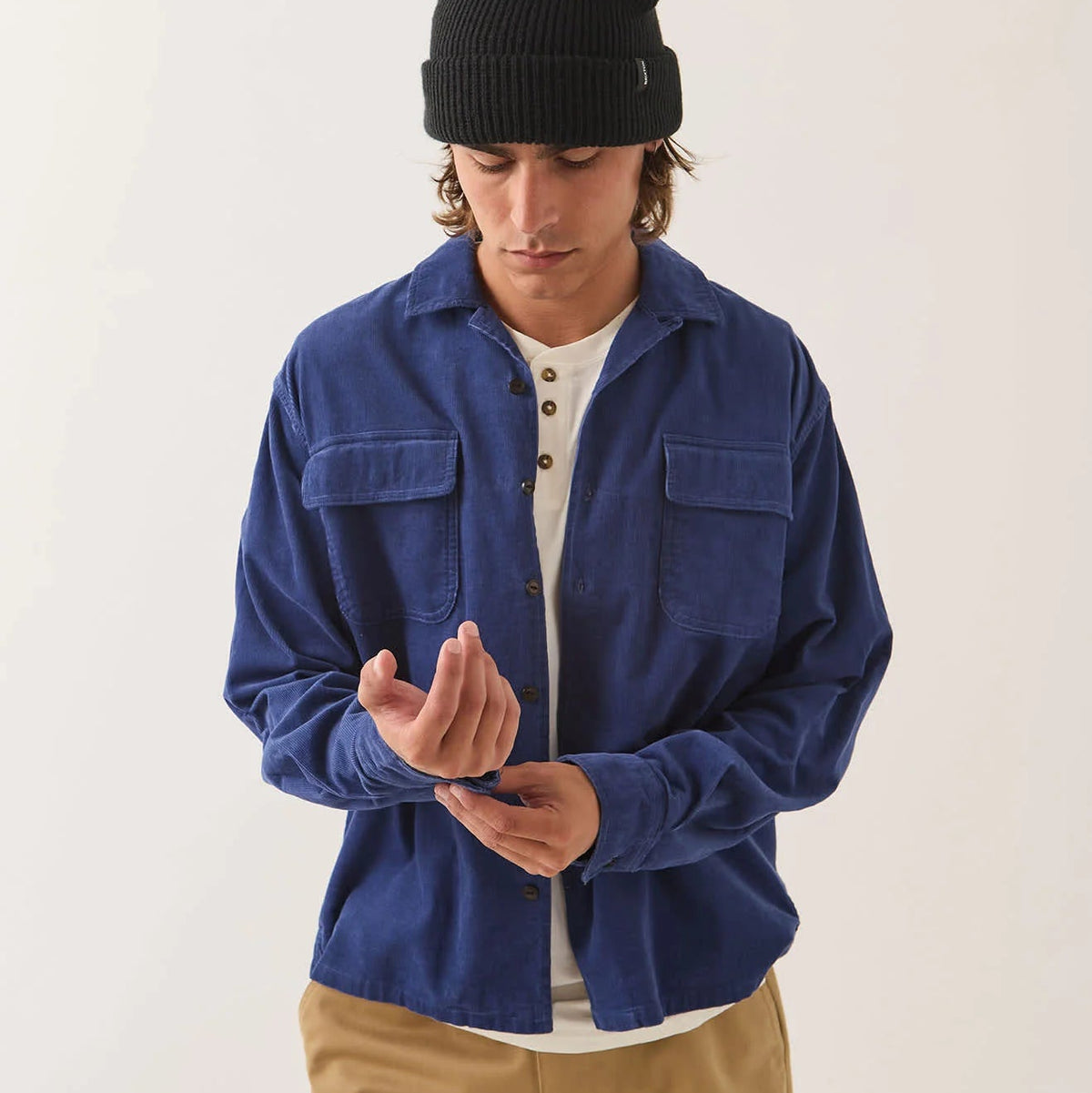 Male model wearing Brixton Men's Century Overshirt in Blue & Navy Shadow on plain background.