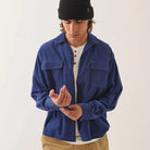 Male model wearing Brixton Men's Century Overshirt in Blue & Navy Shadow on plain background.