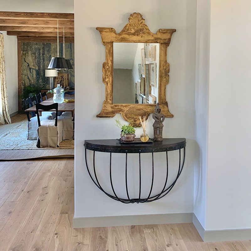 Stable Console demilune wall mounted console table on a white wall at Addison West