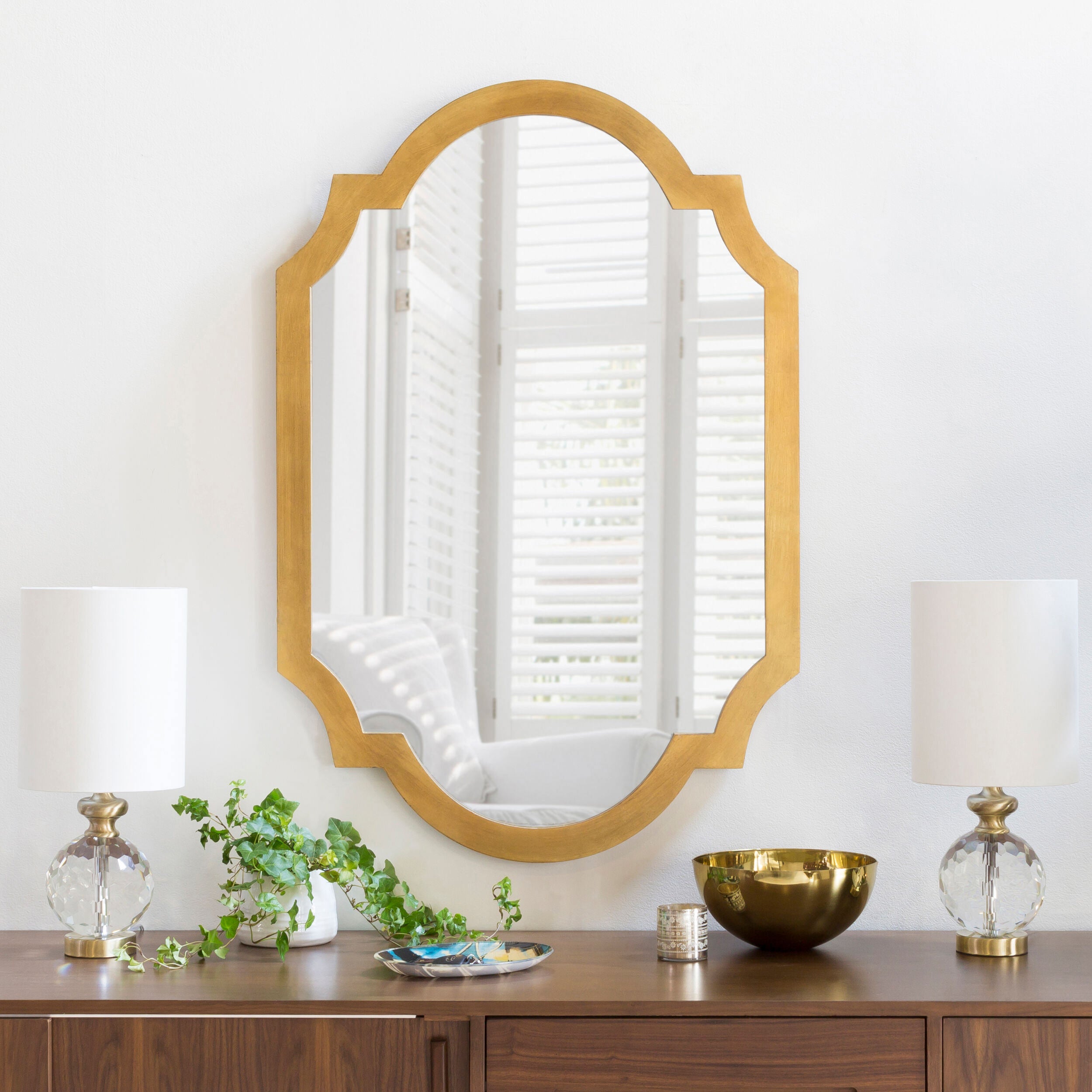 Norway Accent Mirror on a white wall above a table at Addison West