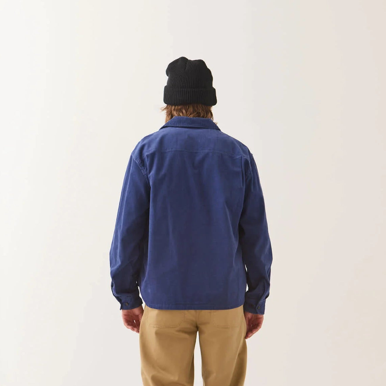 Male model wearing Brixton Men's Century Overshirt in Blue & Navy Shadow on plain background.