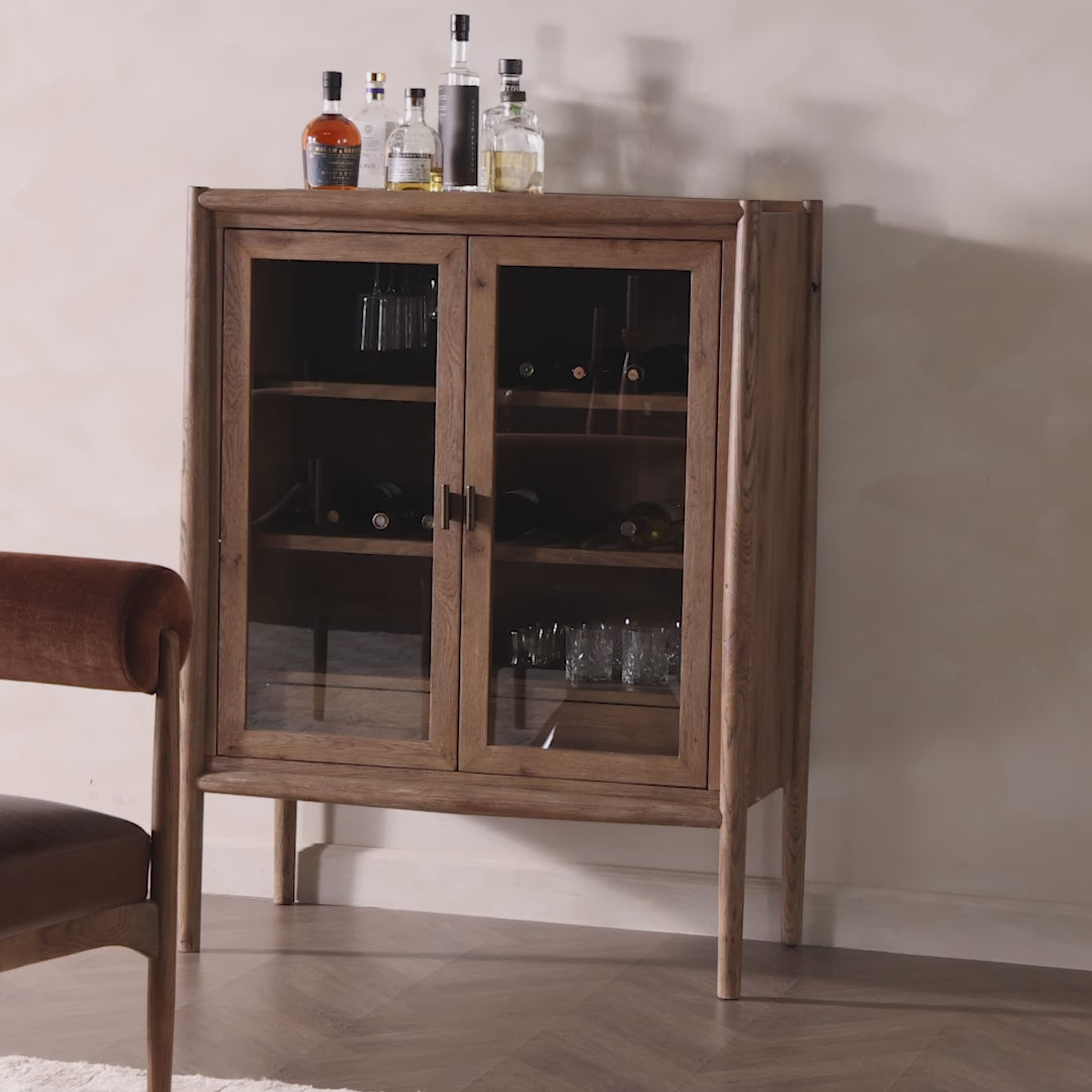 Video of Four Hands Glenview Bar Cabinet in Weathered Oak on a white wall at Addison West