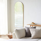 Aranya Arch Full Length Mirror on a white wall in a living room at Addison West