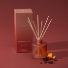 Thymes Pomander Clove Petite Diffuser 4oz on a red background at Addison West