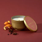 Thymes Pomander Clove Tin Candle 6.5oz on a red background at Addison West