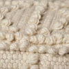 Close up of Cream wool Leroy pouf with popcorn design on a white background