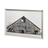 Rustic wood barn in snow framed art print on a white background