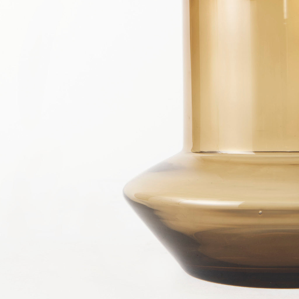 Amber glass vase with modern shape on a white background  Edit alt text