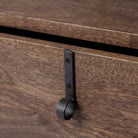 Square wood end table with black iron legs and drawer and rustic pull on a white background