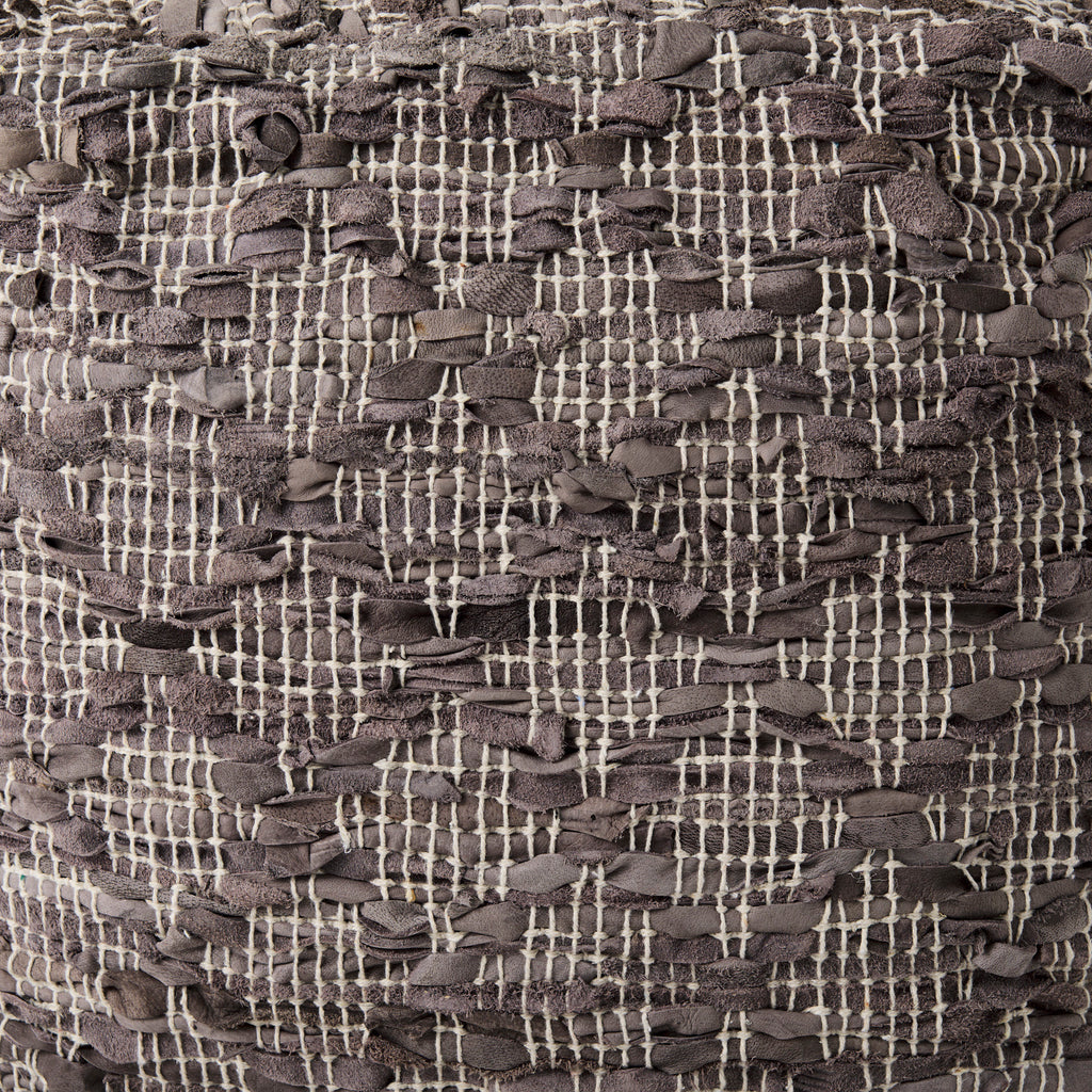 Close up of fabric on Grey square pouf with cotton and leather accents in geometric pattern on a white background