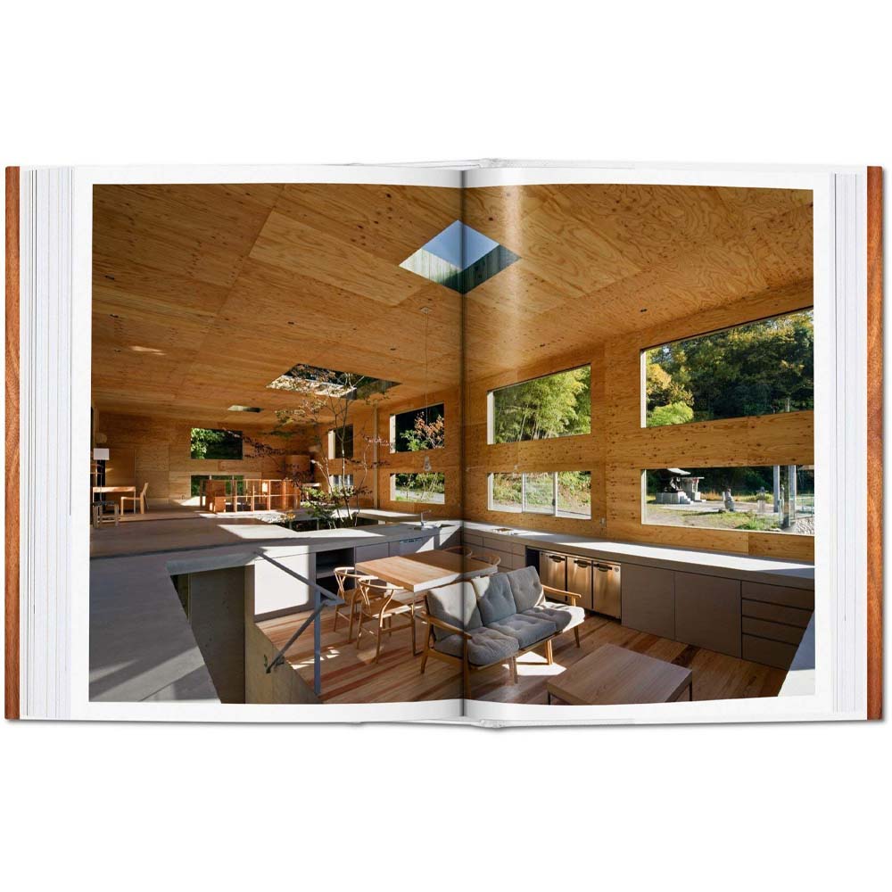 Interior pages of book: 100 Contemporary Wood Buildings showing wood paneled living room with plywood