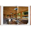 Interior pages of book: 100 Contemporary Wood Buildings showing wood paneled living room with plywood