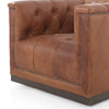 Four hands brand Maxx squared arm Chesterfield style swivel chair in brown leather with nail heads on a white background