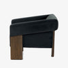 Side view of Four Hands Furniture brand Cairo chair in dark blue velvet with dark wood legs on a white background
