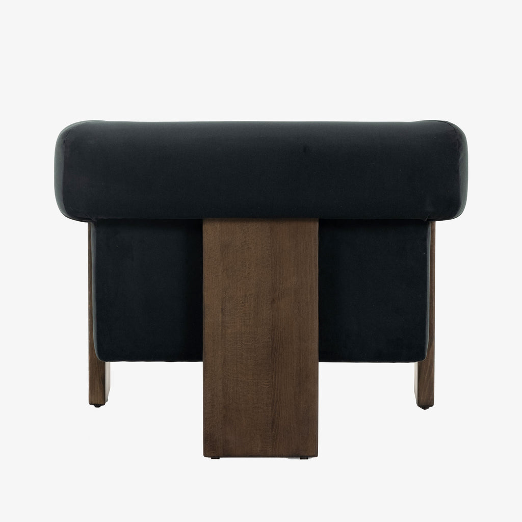 Back view of Four Hands Furniture brand Cairo chair in dark blue velvet with dark wood legs on a white background