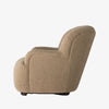 Side view of our hands furniture brand Kadon chair in camel color boucle on a white background