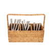 Rectangular rattan caddy with handle and three compartments on a white background with silverware