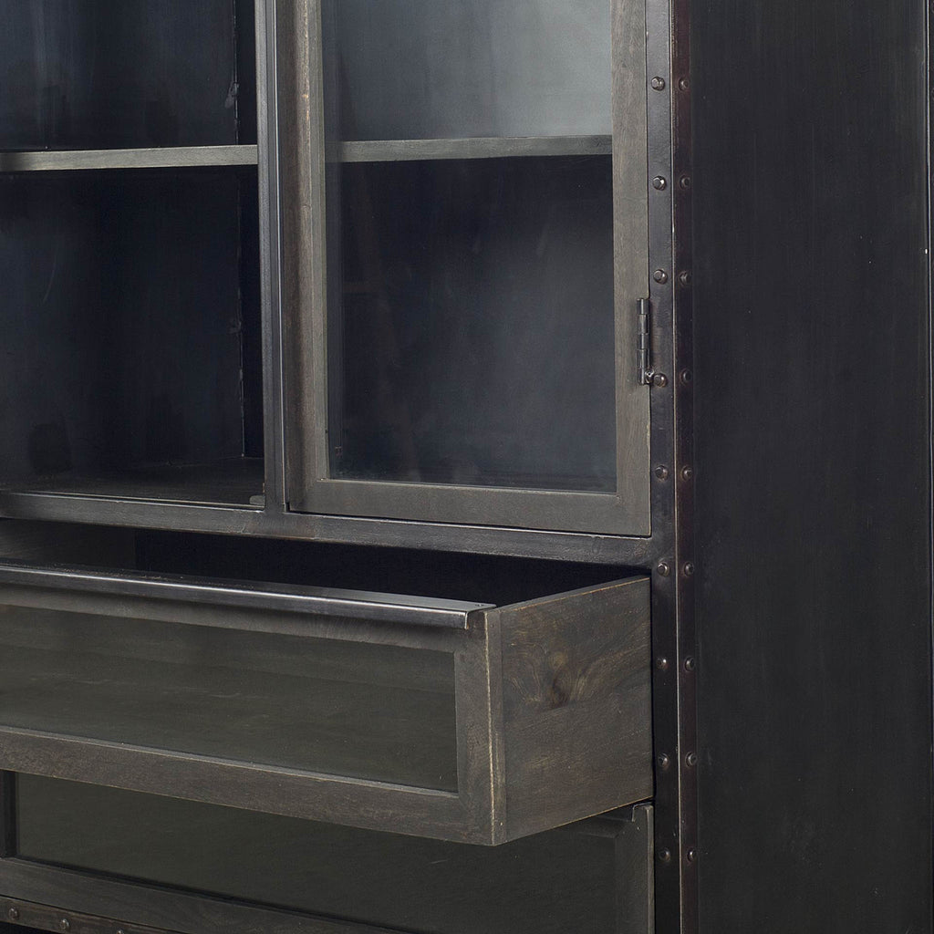 Close up of Black riveted metal and wood cabinet with glass doors and curved top on a white background