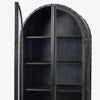 close up of Black riveted metal and wood cabinet with glass doors and curved top on a white background