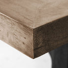 Large rectangular wood dining table with trestle style iron base on a white background