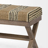 Wood bench with jute yellow and black and white striped upholstered cushion on a white background