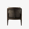 Armchair with dark brown stain and sloped arms and cane back and light beige cushions on a white background