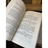 Inside pages of book titled 'The woman suffrage cook book' on a white background