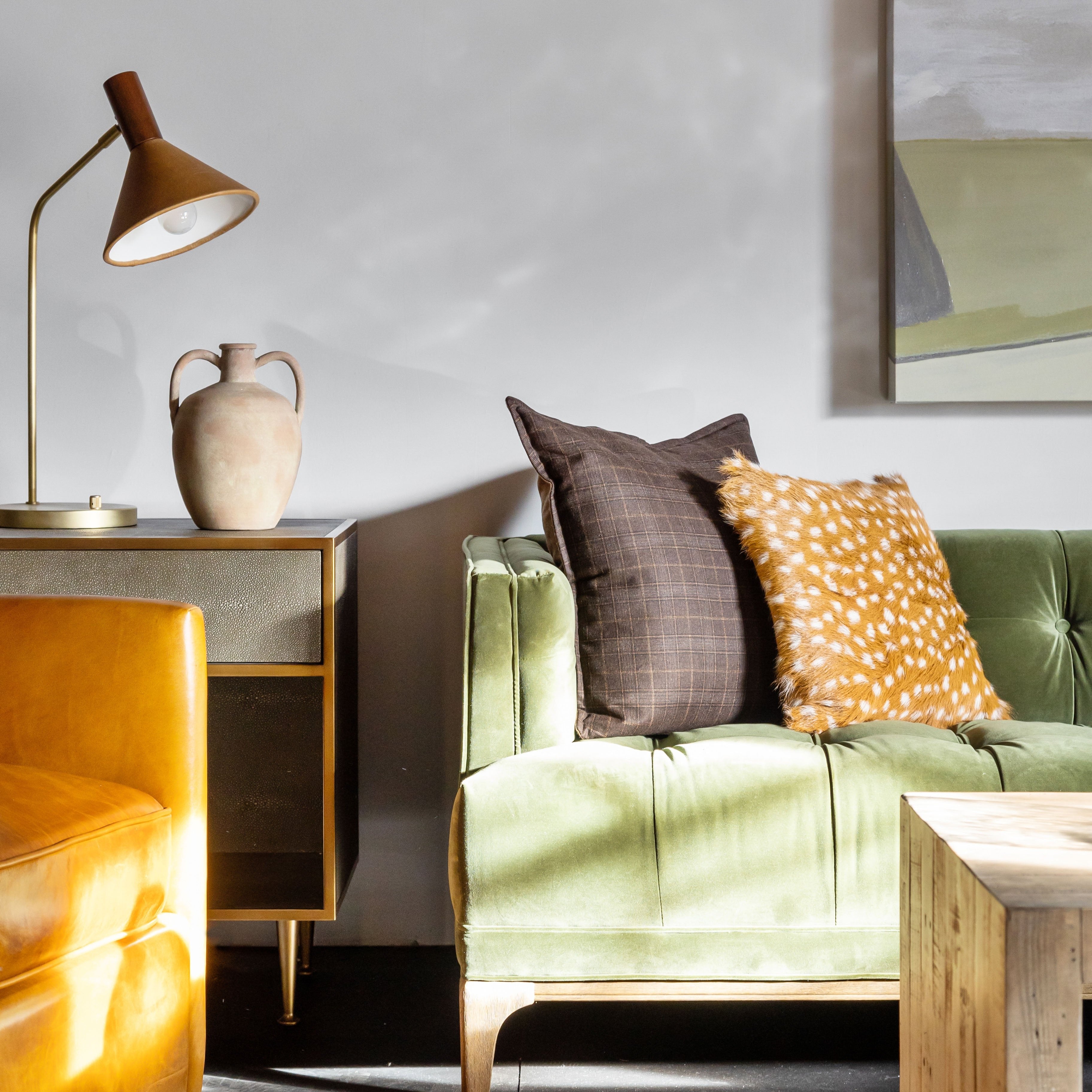 Living room with green sofa and four hands brand 'Cullen' task lamp on top of end table