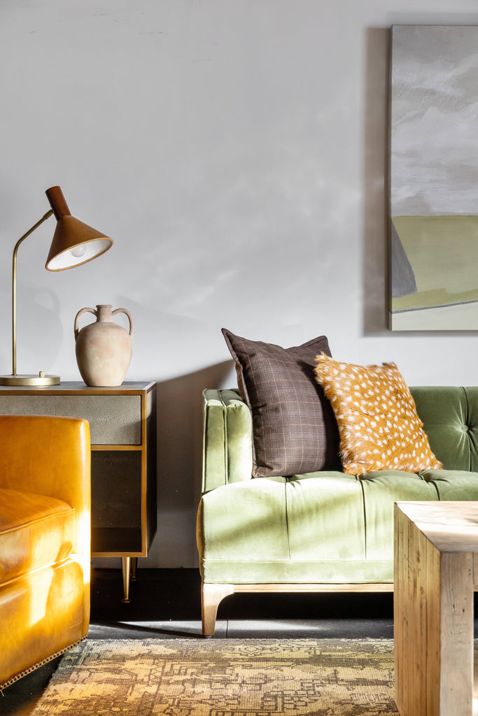 Living room with green sofa and four hands brand 'Cullen' task lamp on top of end table