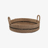 Low round woven basket with black accent and handles on a white background