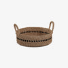 Low round woven basket with black accent and handles on a white background