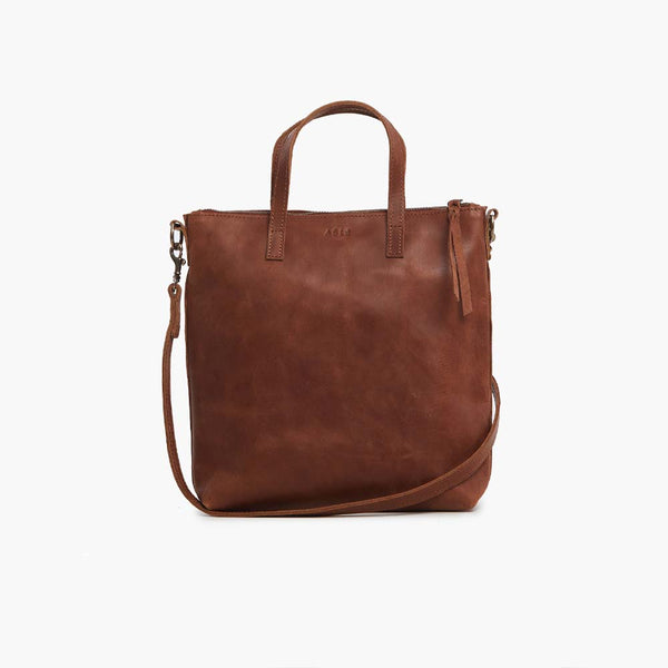 Able brand Abera Commuter bag in whiskey leather on a white background.