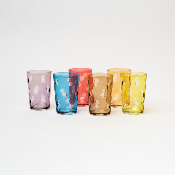 Multi colored moroccan tea glasses with bubble pattern on a white background
