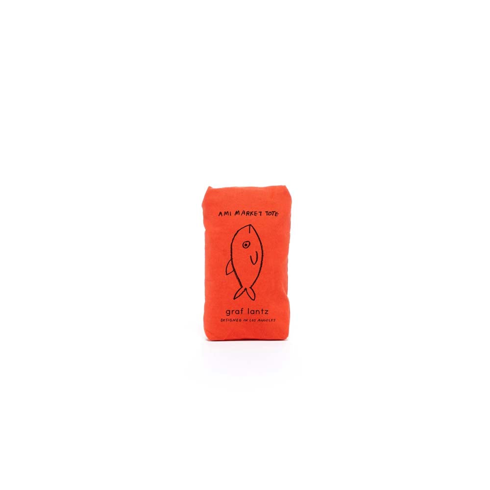 Graf Lantz orange market tote bag packaged into pocket on a white background