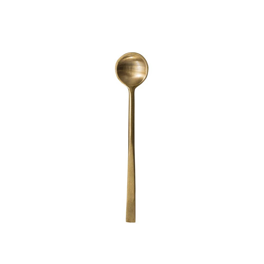 Antique brass finish spoon on a white background