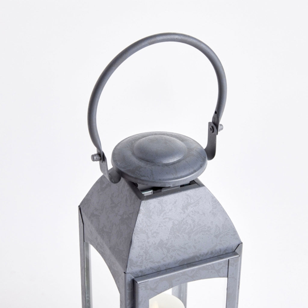 Zinc metal square outdoor lantern with arched top handle on a white background