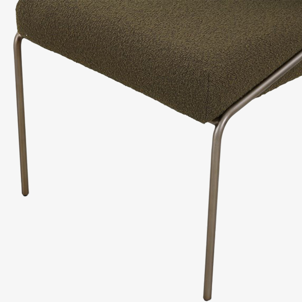 Close up of Four Hands Brand Astrud dining chair with boucle olive fabric seat and back and iron legs on a white background
