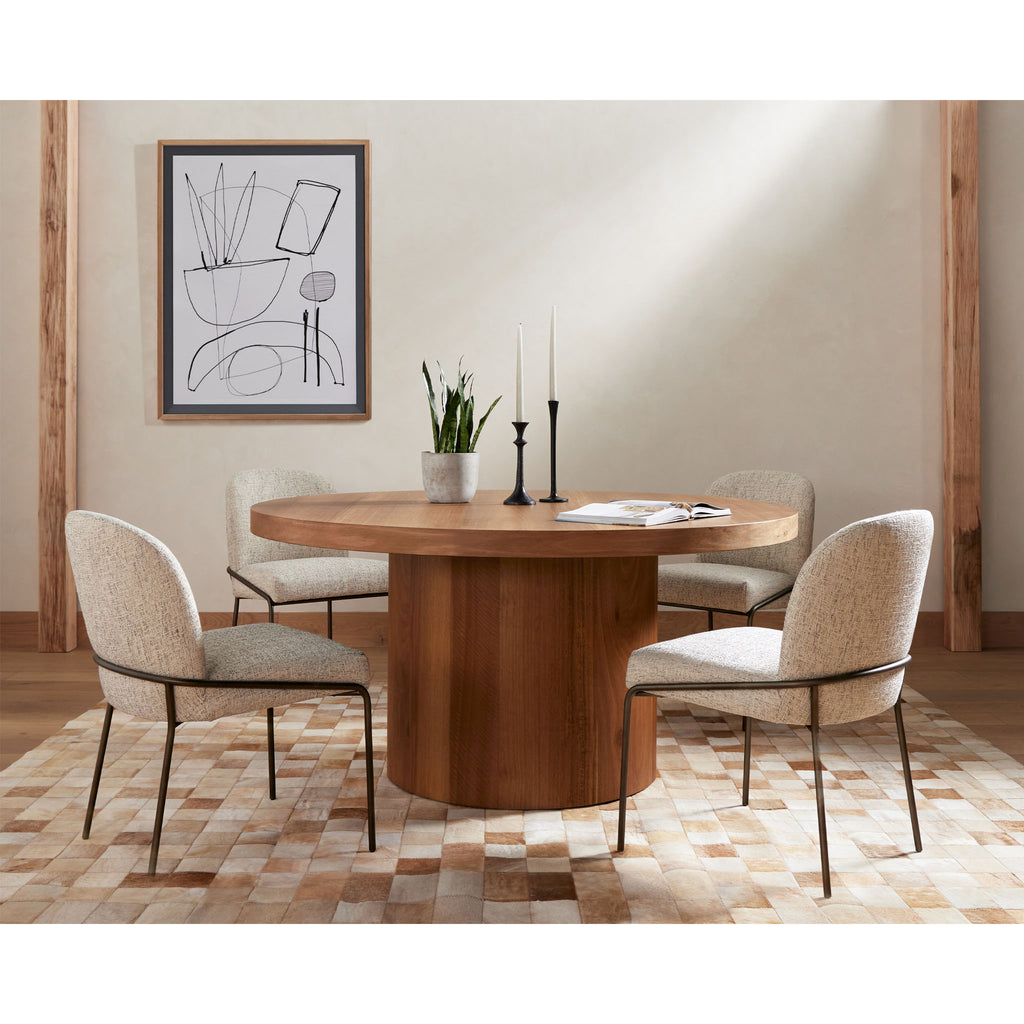 Four Hands Brand Astrud dining chair with pewter fabric seat and back and iron legs around a wood dining table
