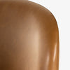 Close up of Sierra Butterscotch leather on Four Hands Brand Astrud dining chair with brown leather seat and back and iron legs on a white background