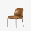 Four Hands Brand Astrud dining chair with brown leather seat and back and iron legs on a white background