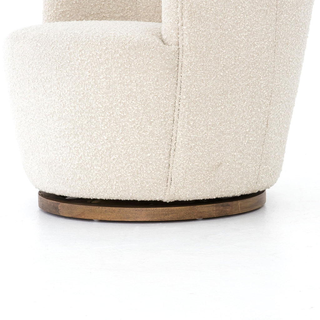 Close up of base on Aurora swivel chair in Knoll natural creme color by Four Hands Furniture brand with wood base on a white background