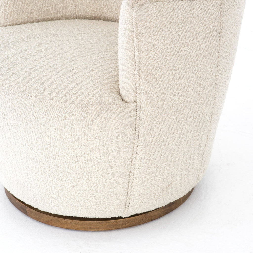 Close up of Aurora swivel chair in Knoll natural creme color by Four Hands Furniture brand with wood base on a white background