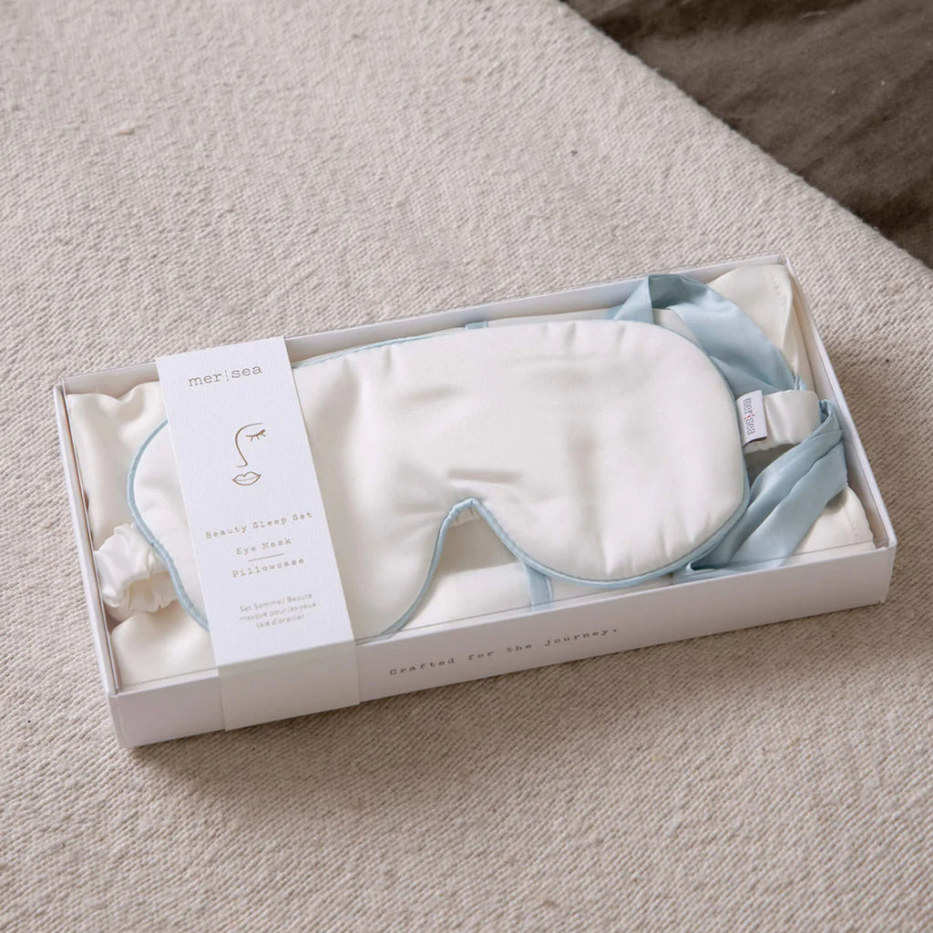 Mer Sea brand satin pillow case and eye mask in box on a cream colored material