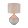 Surya Blakey table lamp with round white base and linen shade on a white background