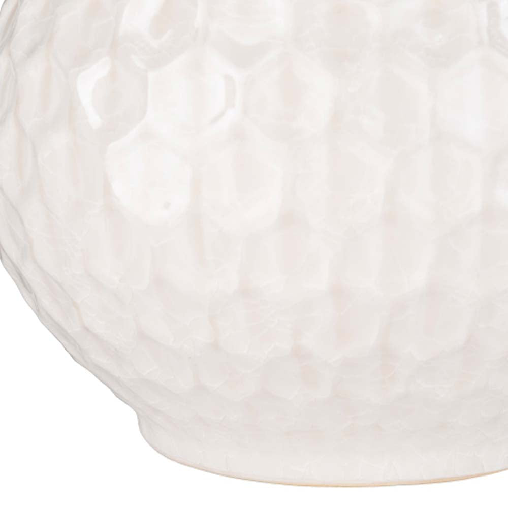 Close up of Surya Blakey table lamp with round white base and linen shade on a white background