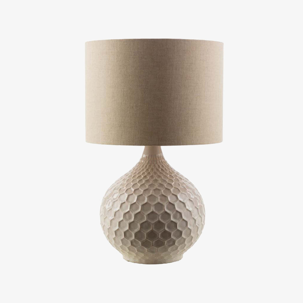Surya brand Blakey table lamp with round white base and linen shade on a white background
